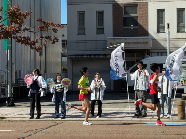 大学の法被を着て沿道から声援を送る学生たちPNG